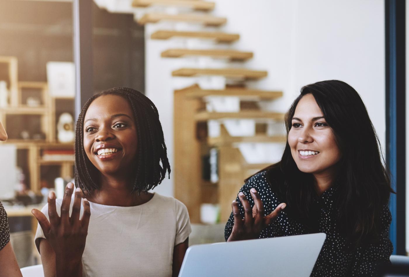 Several people meeting at a boardroom table.